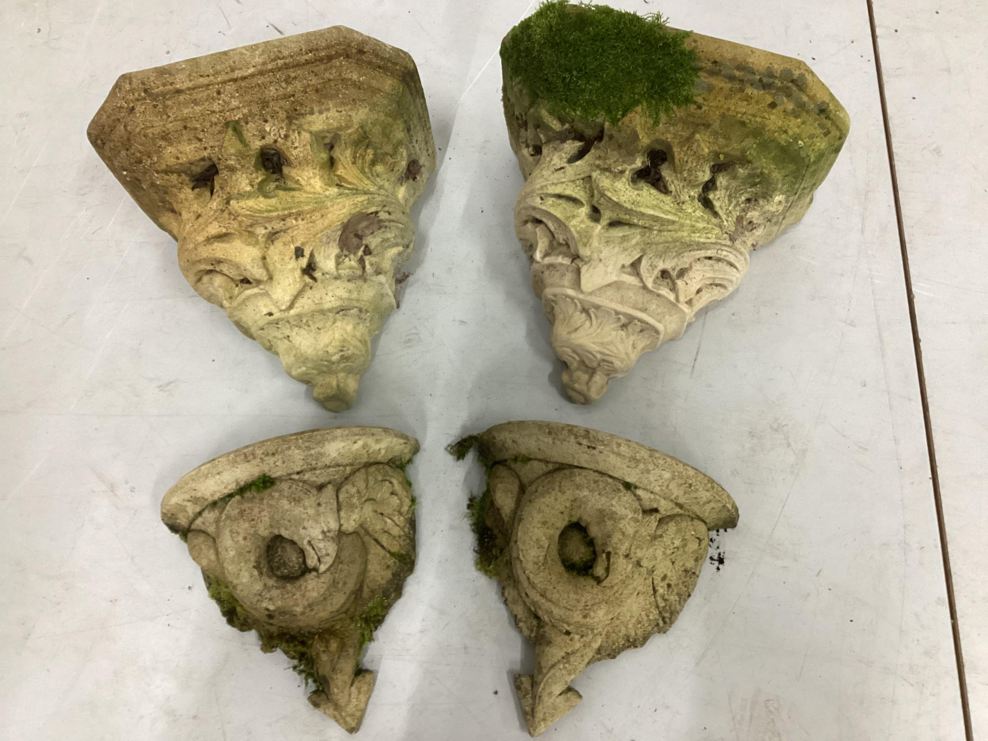 Two pairs of cast stone garden corbel wall brackets, largest width 30cm, height 26cm